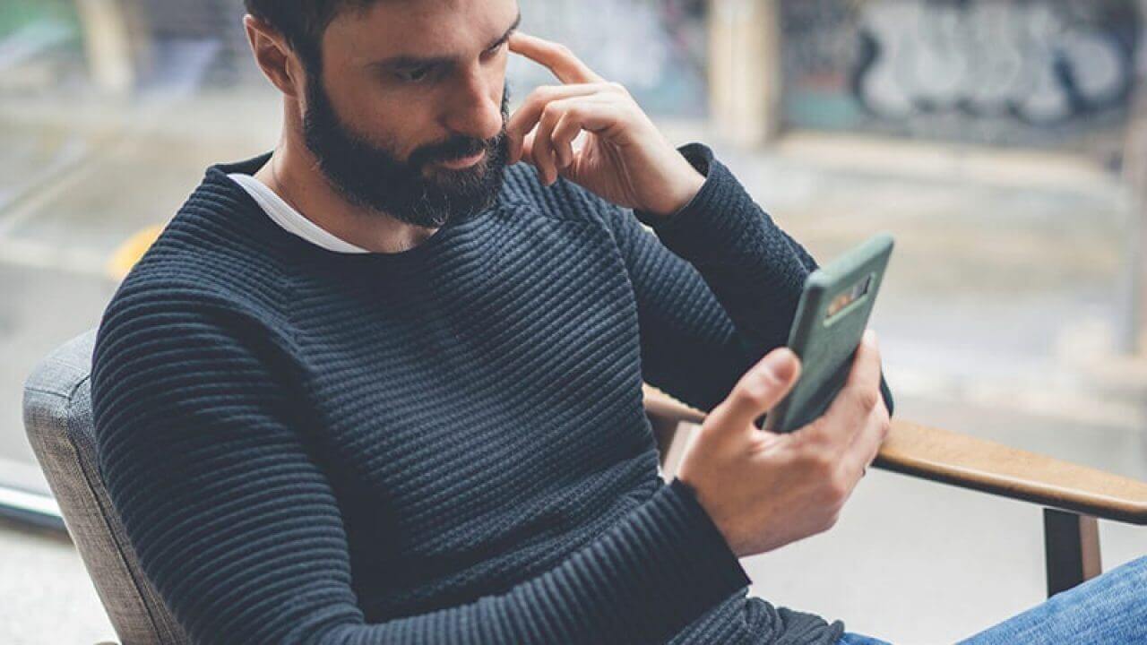 man reading with android phone