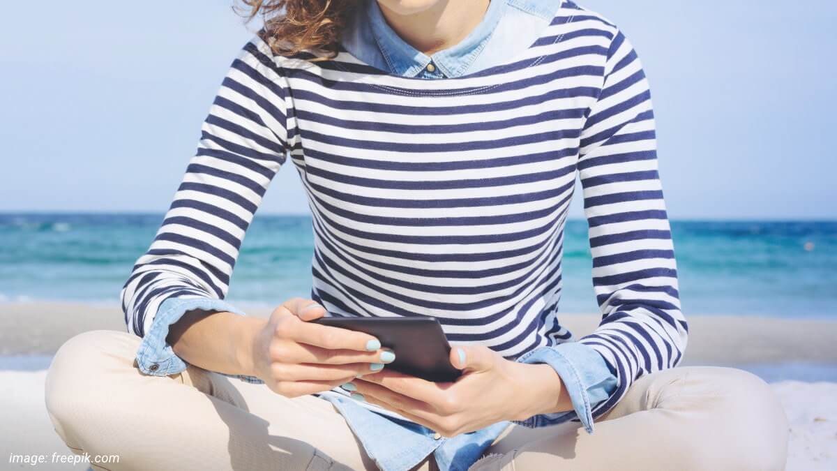Woman binge reading on Kindle