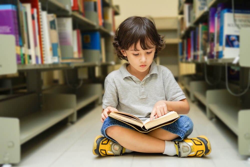 kid reading print book