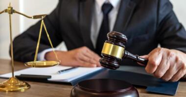 judge banging gavel on table free photo
